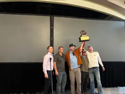 adults holding trophy